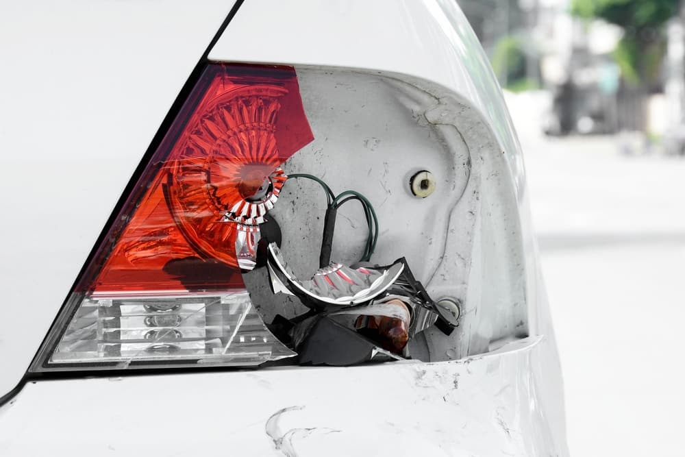 A car with a broken tail light, which can lead to a car accident due to a defective part.
