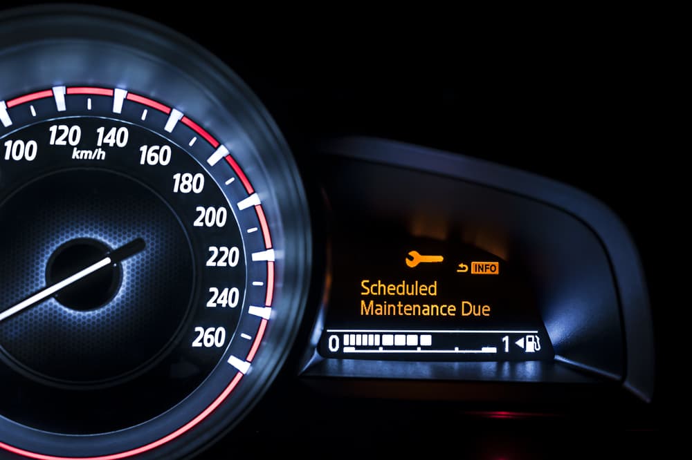 Car dashboard indicating maintenance is due