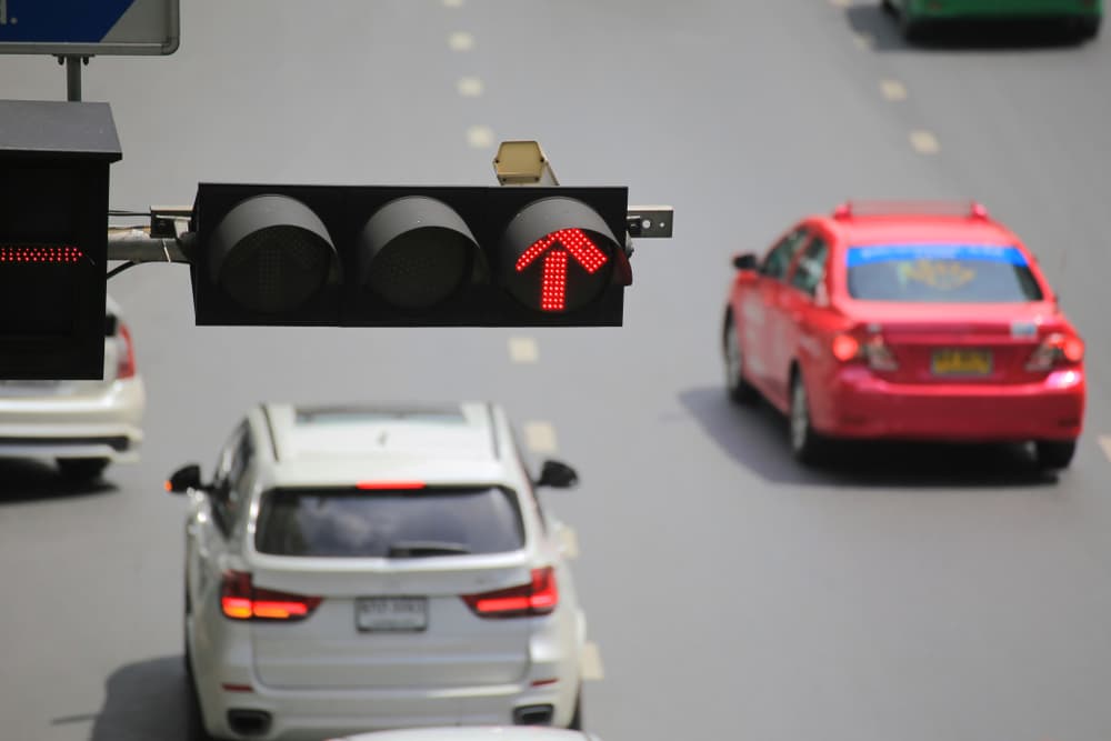 Cars driving past red light failing to obey traffic laws.