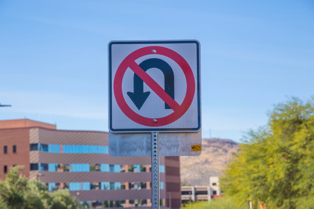 traffic sign showing a u-turn is illegal.