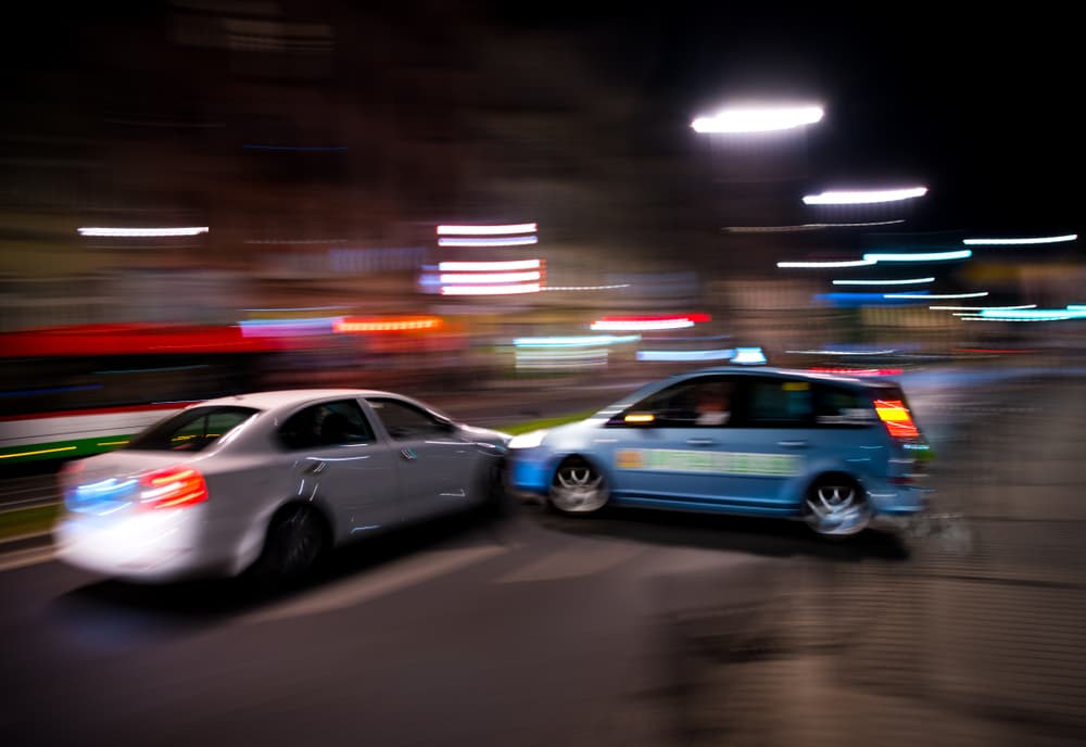 A car accident at night, which is often caused by driver fatigue.