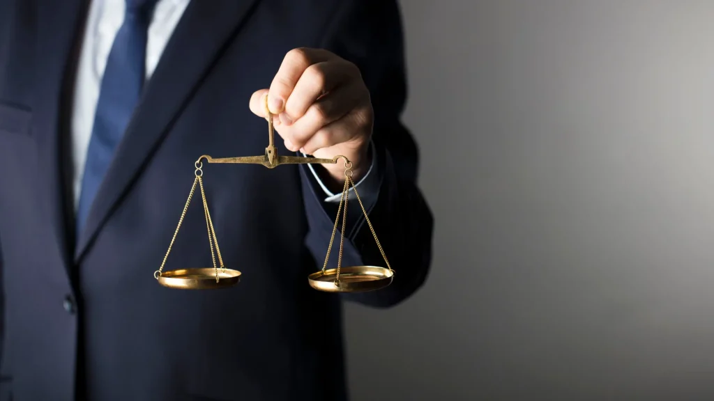 Lawyer holding golden scales of justice