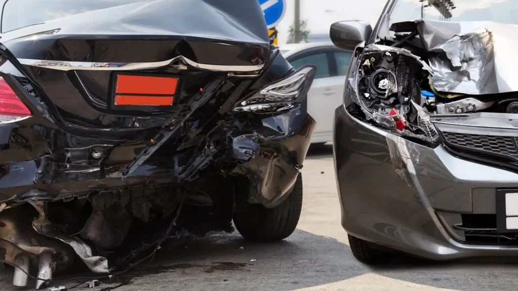 Two cars with heavy rear-end and front-end damage after collision